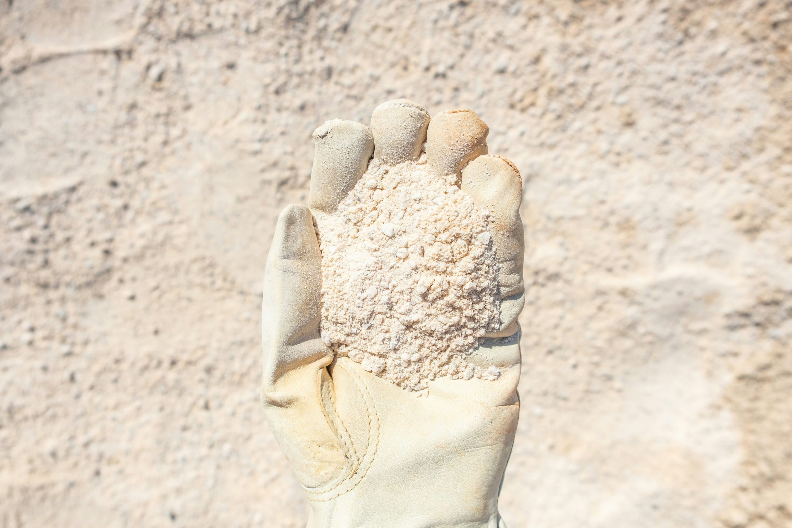 A climber demonstrating finger stretches before ascending.